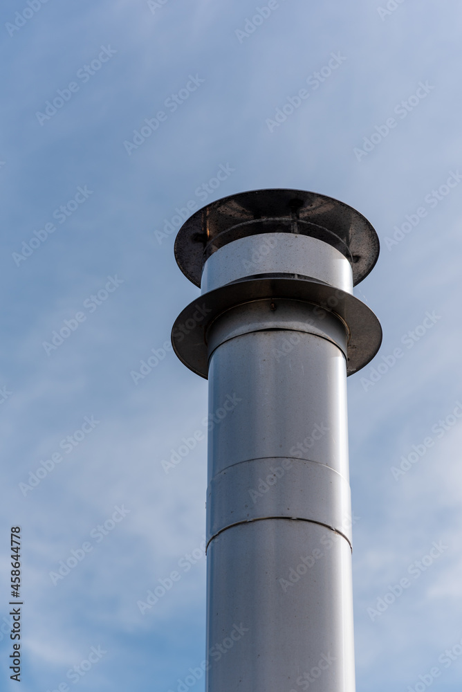 steel chimney against blue sky low angle view in Rotterdam, Netherlands steel chimney against blue sky low angle view in Rotterdam, Netherlands