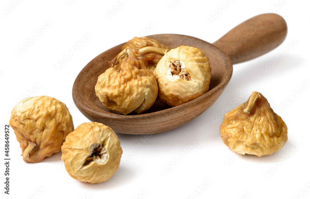 close up of dried fig fruits in the wooden spoon, isolated on the white background close up of dried fig fruits in the wooden spoon, isolated on the white background