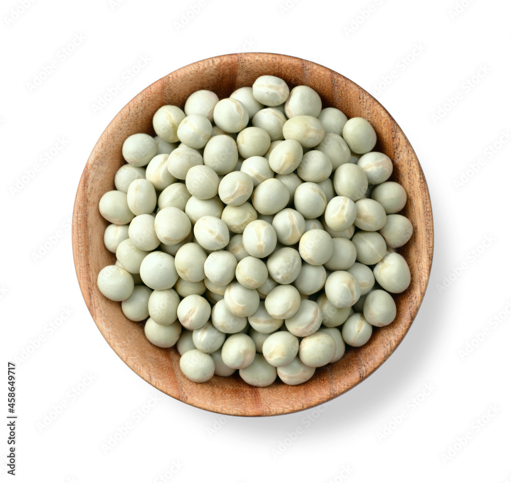 uncooked dried green peas in the wooden bowl, isolated on the white background, top view uncooked dried green peas in the wooden bowl, isolated on the white background, top view