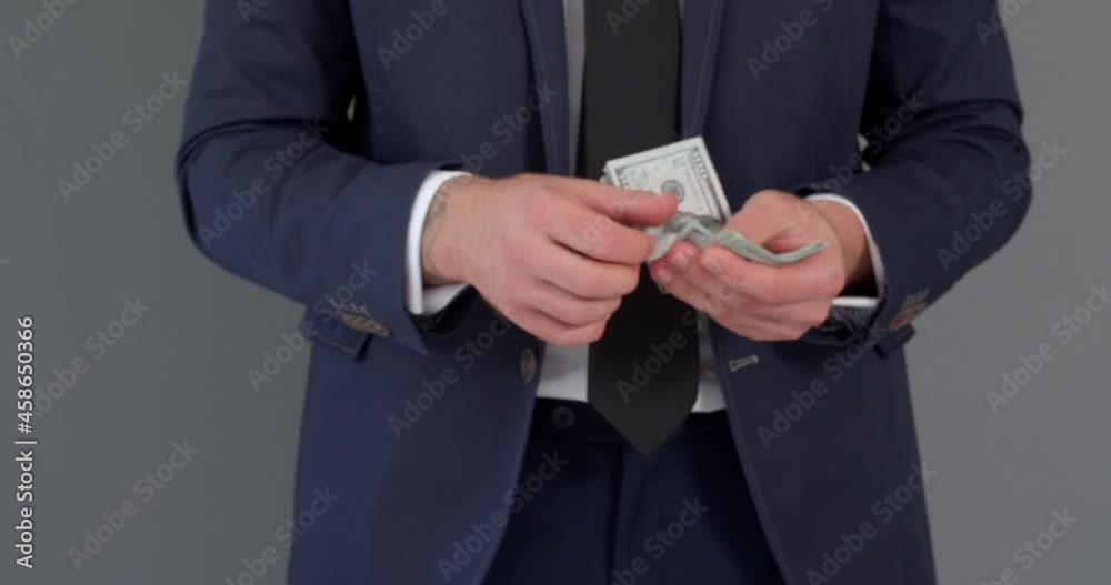 Businessman counting money on grey background Businessman counting money on grey background