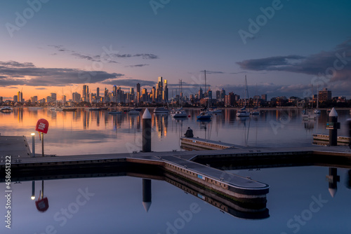 Melbourne, Victoria, Australia - August 2021: Melbourne city skyline at dusk, from the Royal Melbourne Yacht Squadron marina on Port Phillip Bay in St Kilda. photo