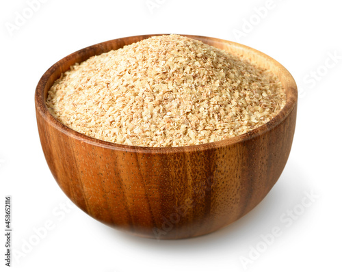 uncooked wheat germ in the wooden bowl, isolated on the white background