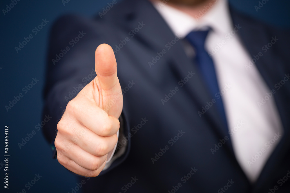 Business man shows thumb up Business man shows thumb up