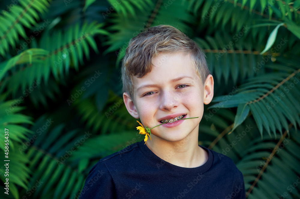Portrait of a boy with braces in nature . Portrait of a boy with braces in nature .