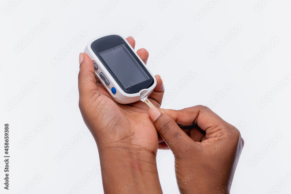 Close up of hands of an unrecognizable woman holding a glucometer Close up of hands of an unrecognizable woman holding a glucometer
