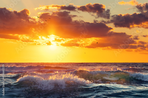 Golden splashing waves and sunrise sea