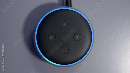 Overhead shot of smart speaker activated by voice command control with blue light ring photo