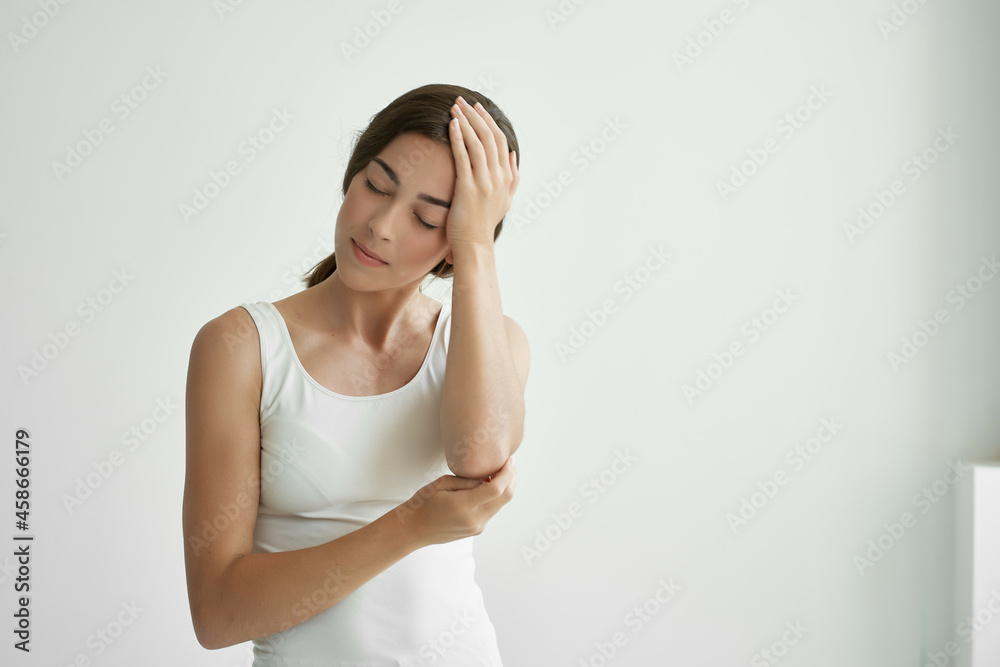 woman in white t-shirt holding her head health problems depression migraine woman in white t-shirt holding her head health problems depression migraine