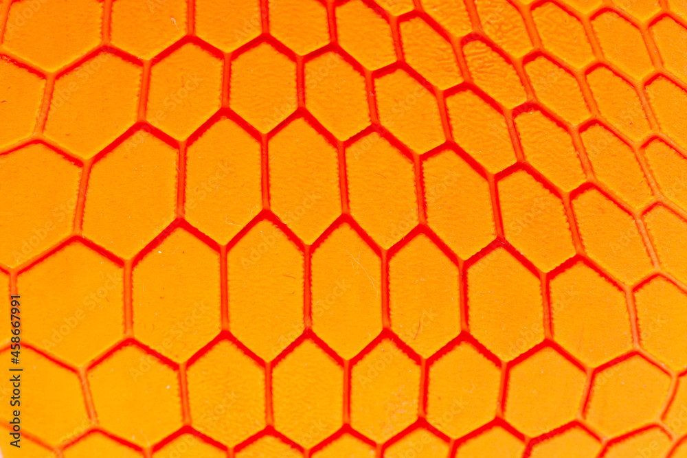 Orange hexagon pattern background Is a rubber decorated closeup.Orange hexagon abstract background texture.Macro shot. Orange hexagon pattern background Is a rubber decorated closeup.Orange hexagon abstract background texture.Macro shot.