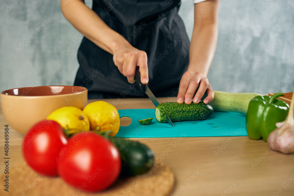Woman in black apron Cooking healthy eating cutting board Woman in black apron Cooking healthy eating cutting board