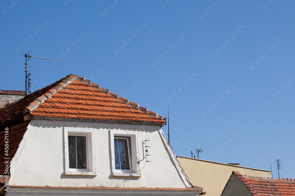 Townhouses with sloping roofs and mounted antennas.