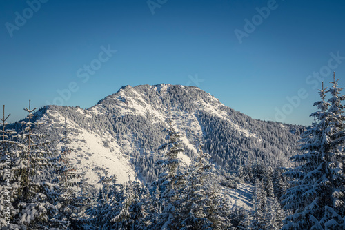 Rocky peak and clear blue winter sky, Western Tatra Mountains, Poland. Bobrowiec (Bobrovec in Slovak) Summit. Selective focus on the ridge, blurred background. photo