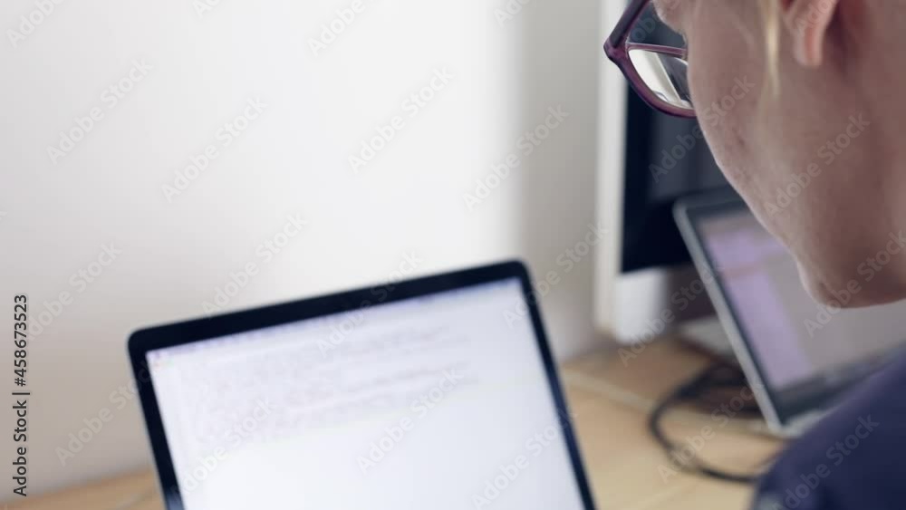 Business woman typing on computer keyboard at office workplace, video footage