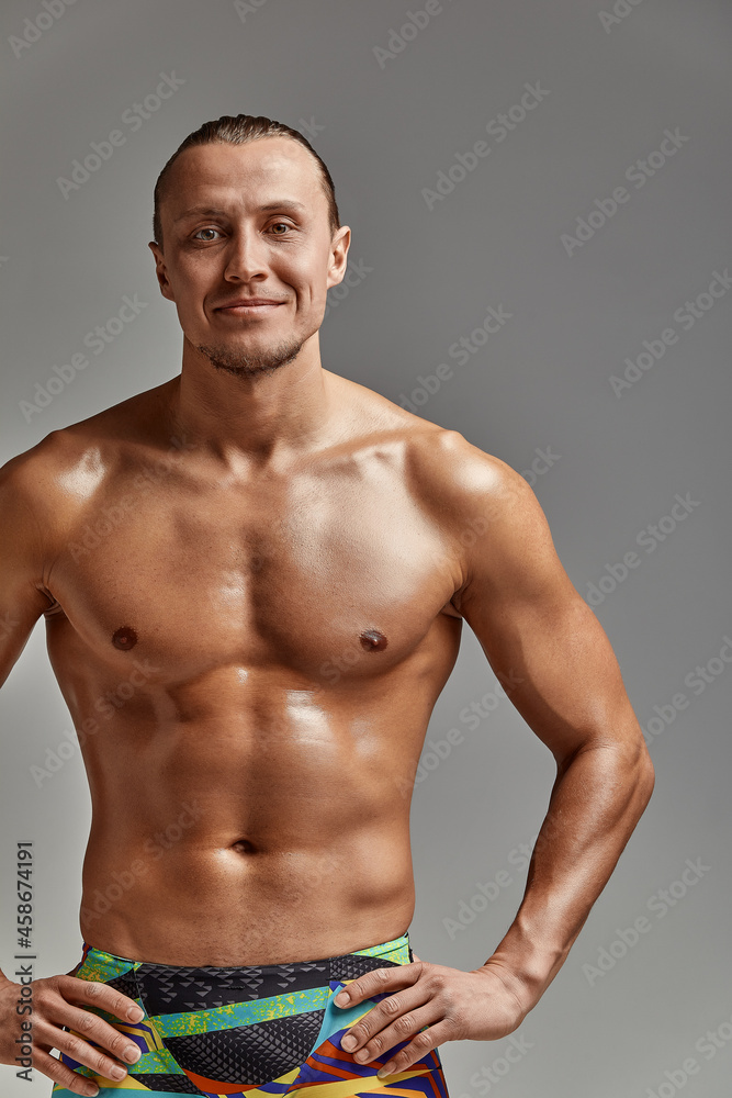 Portrait of a swimmer in a cap and mask, half-length portrait, young athlete swimmer wearing a cap and mask for swimming, copies of space, gray background Portrait of a swimmer in a cap and mask, half-length portrait, young athlete swimmer wearing a cap and mask for swimming, copies of space, gray background