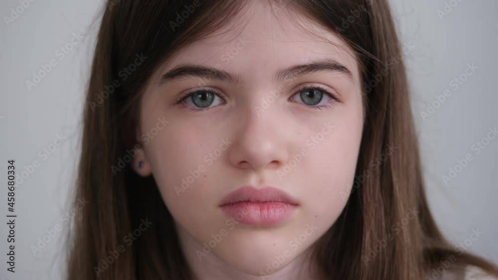 portrait of a small, young sad girl with big blue eyes portrait of a small, young sad girl with big blue eyes