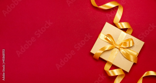 Festive template or banner with Christmas gift box decorated with a bow