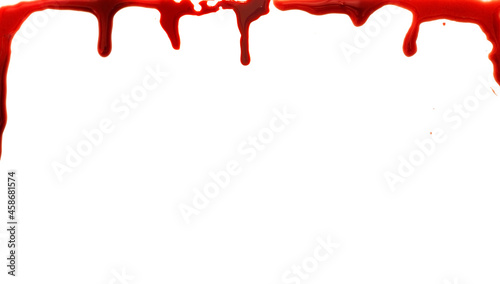 A photograph of blood imitation dropping on a white background. Mockup paper sheet for Halloween purposes. Copy space for additional content.