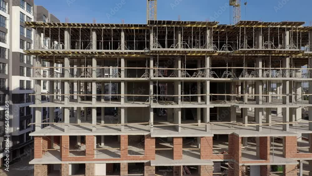 Aerial view of high residential apartment building under construction. Real estate development. Aerial view of high residential apartment building under construction. Real estate development.