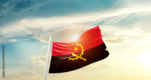 Angola national flag cloth fabric waving on beautiful sky - Image