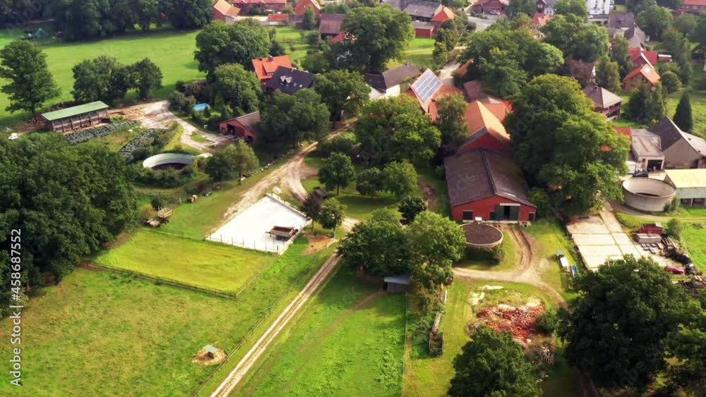 Aerial view of a farm with slurry tank at the edge of a village in Germany Aerial view of a farm with slurry tank at the edge of a village in Germany