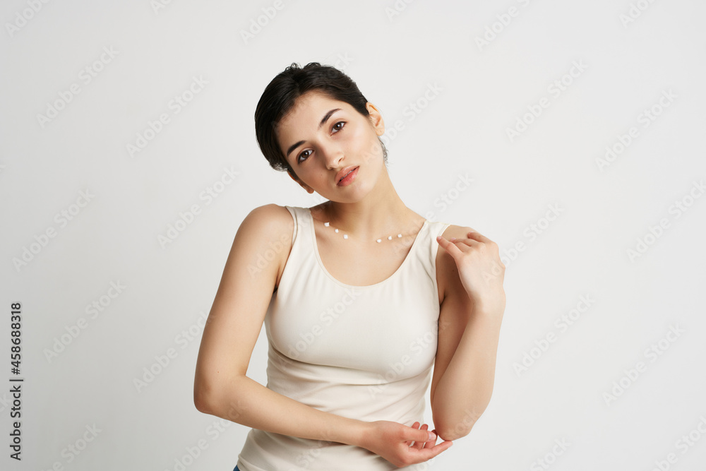 brunette in white tank top cream jar moisturizing health care brunette in white tank top cream jar moisturizing health care