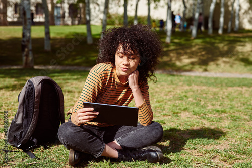 Attractive young woman reading from a tablet pc