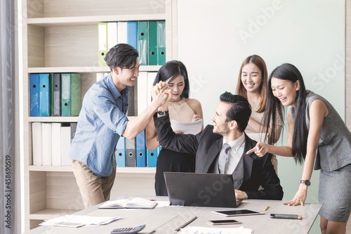 Manager and his team having meeting at meeting room in office.