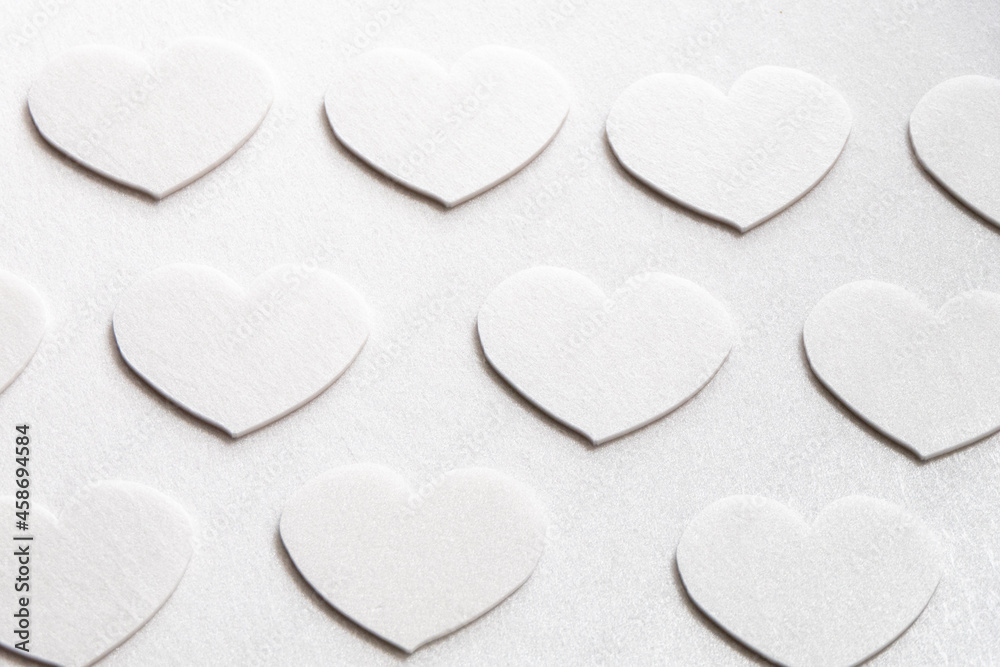 Simple white hearts on a white background