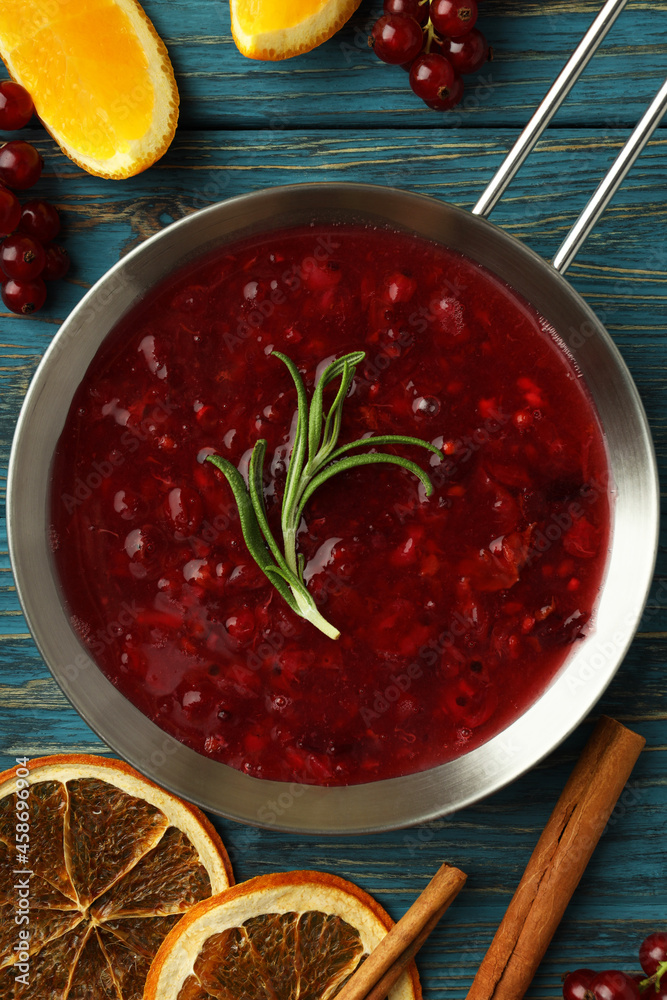 Cranberry sauce and ingredients on wooden background Cranberry sauce and ingredients on wooden background