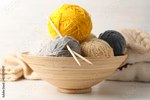 Concept of knitting on white wooden table