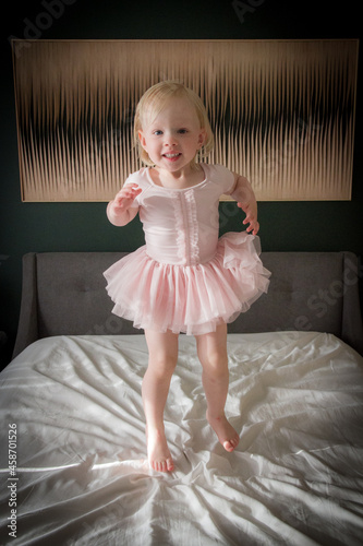Happy toddler girl dancing indoors