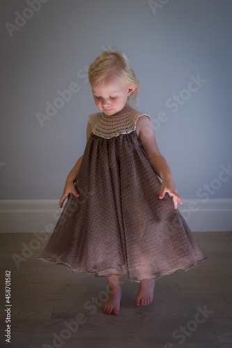 Happy toddler girl dancing indoors