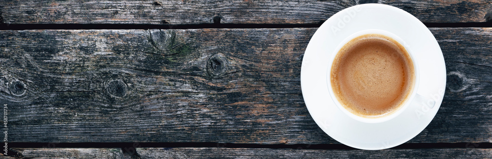 Cup with coffee on wooden old boards. Panorama. View from above. Cup with coffee on wooden old boards. Panorama. View from above.