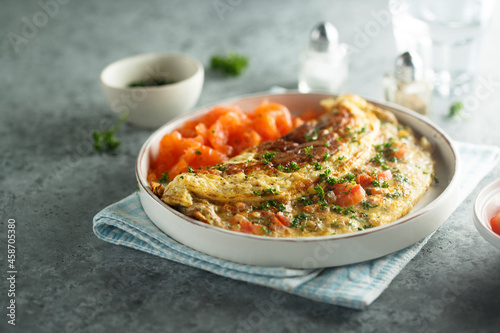 Bild auf Leinwand Traditional homemade omelette with tomatoes and salmon