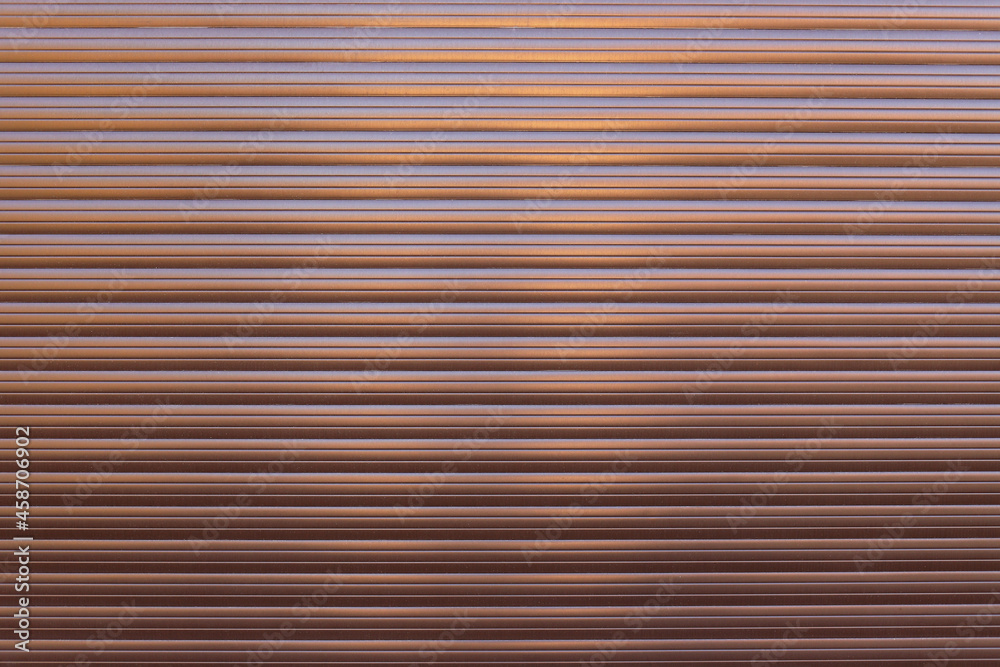 Obraz premium Brown roller shutter door or curtain. Grunge brown metal foldable door background and texture.
