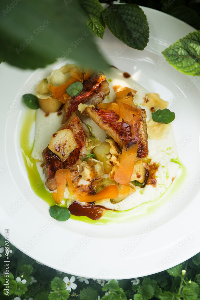 Roasted fish with vegetables and green oil