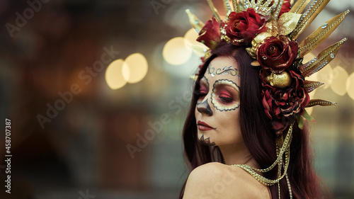 Young woman with painted skull on her face for Mexico's Day of the Dead. portrait of Calavera Catrina in red dress. Sugar skull makeup. Dia de los muertos. Day of The Dead. Halloween