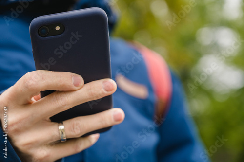 Close-up of the phone in the hands of a man.