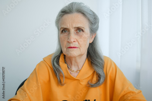 Closeup portrait of angry upset senior mature woman talking with someone and looking at the camera. Negative emotion, facial expression, scandal
