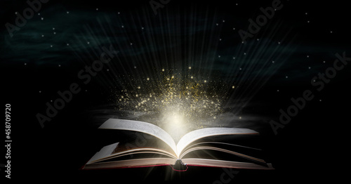 Book With Open Pages And Abstract Lights Shining In Darkness