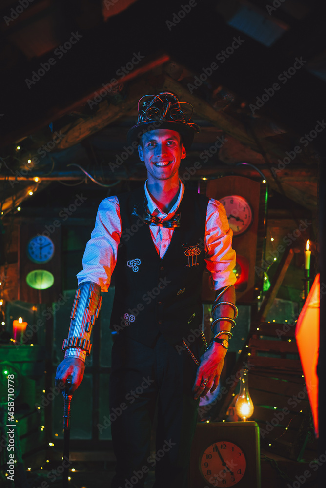 happy male inventor in a steampunk suit, top hat, glasses and with a cane smiles in a watch workshop happy male inventor in a steampunk suit, top hat, glasses and with a cane smiles in a watch workshop