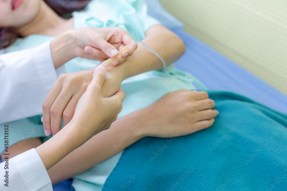 Female doctor preparing a saline tube for patient in the hospital. Female doctor preparing a saline tube for patient in the hospital.
