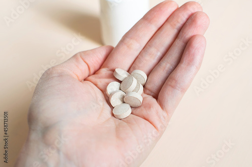 Pills in the woman's hand. Brewer's yeast with zinc.