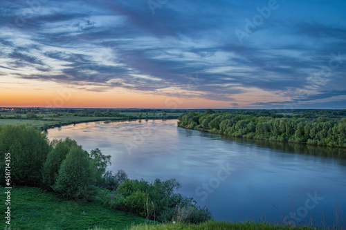 Beautiful evening panorama landscape with river  distance  meadows and fields on the horizon.