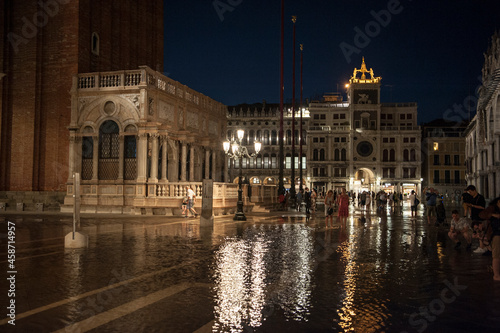 tourists witness the phenomenon of high tide in Piazza San Marco in Venice  © giamplume