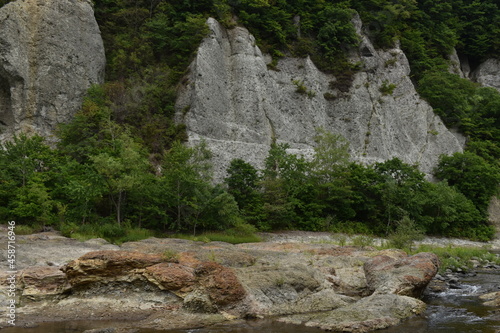 The beautiful rock mountain with the deep green autumn forest in Sapporo Japan