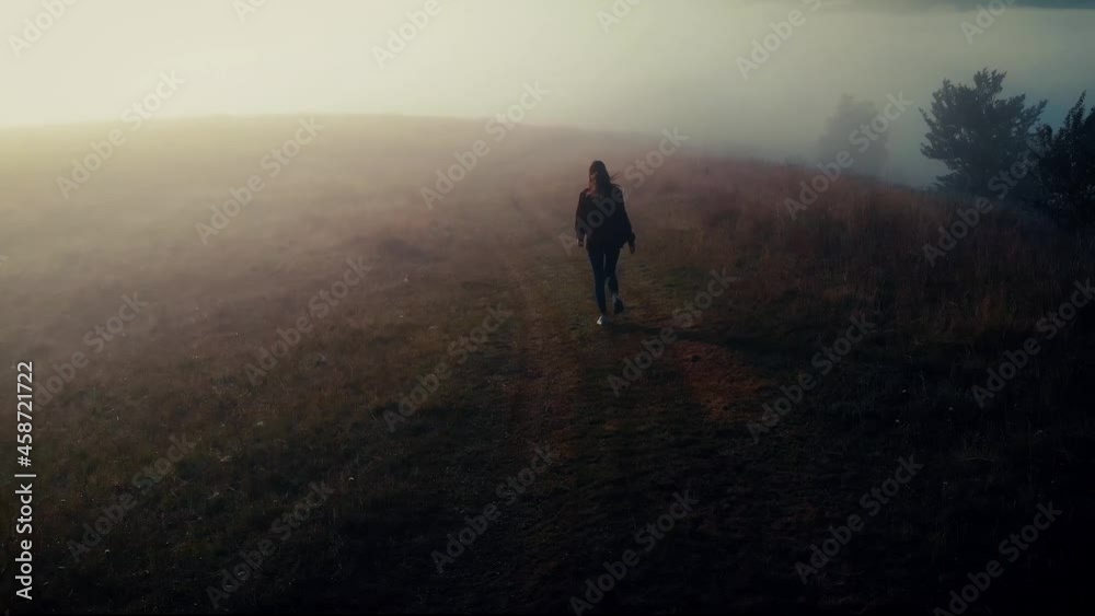 Young Alone Girl Run in Beautiful Misty Advection Fog Morning Landscape in Carpathian Mountains Young Alone Girl Run in Beautiful Misty Advection Fog Morning Landscape in Carpathian Mountains