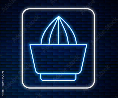 Glowing neon line Citrus fruit juicer icon isolated on brick wall background. Vector