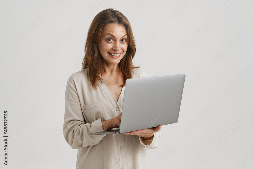 European ginger woman smiling while using laptop European ginger woman smiling while using laptop