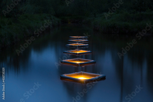 Experimental submersible fish cages lit to attract zooplankton 